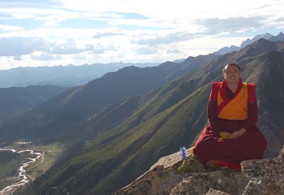Arik Rinpoche sitting near a cliff